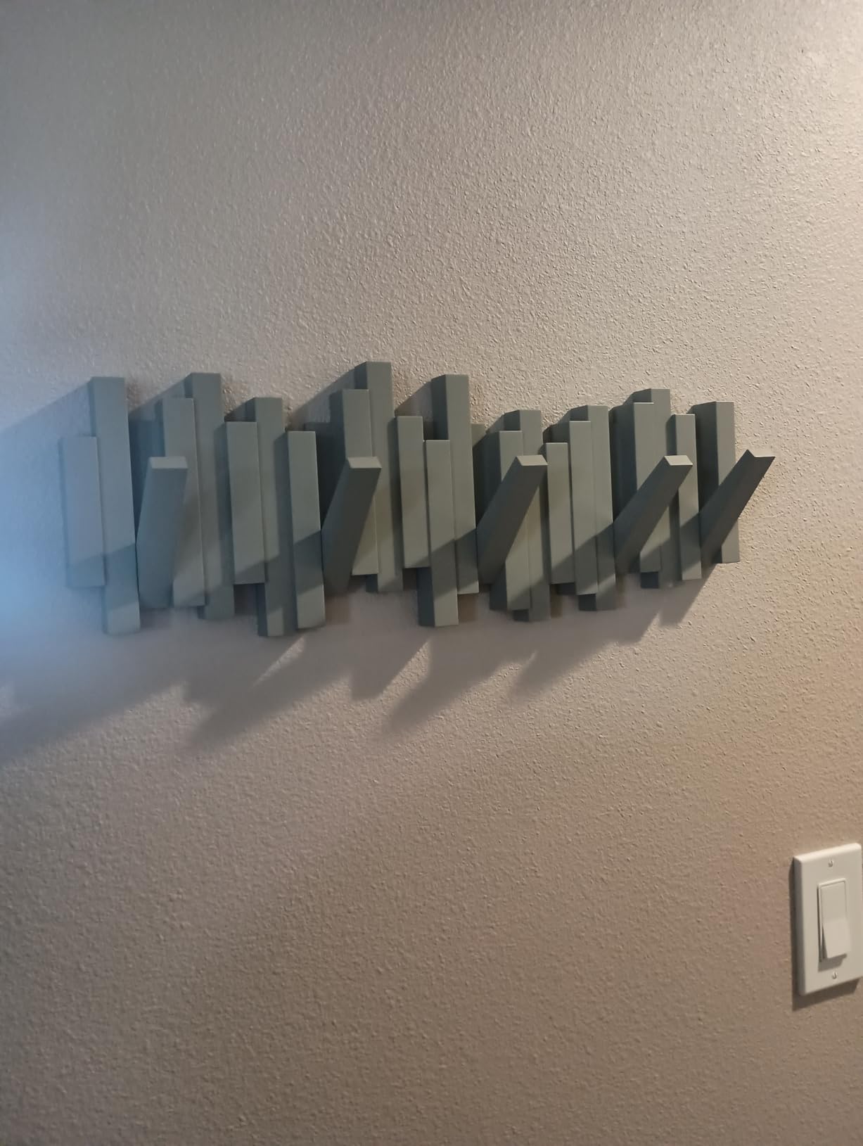 Umbra Sticks Wall Mount Coat Rack, 5 Hook Retractable Pegs, Black | Mounting hardware included, sculptural modern design, entryway or bedroom use, recycled plastic customer photo 2